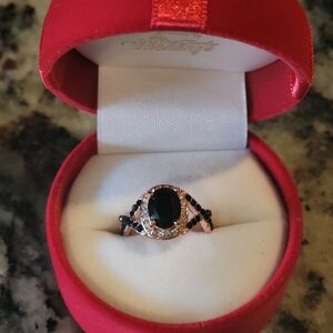 Black Stone ring enclosed with rose gold and cubic zirconium stones
